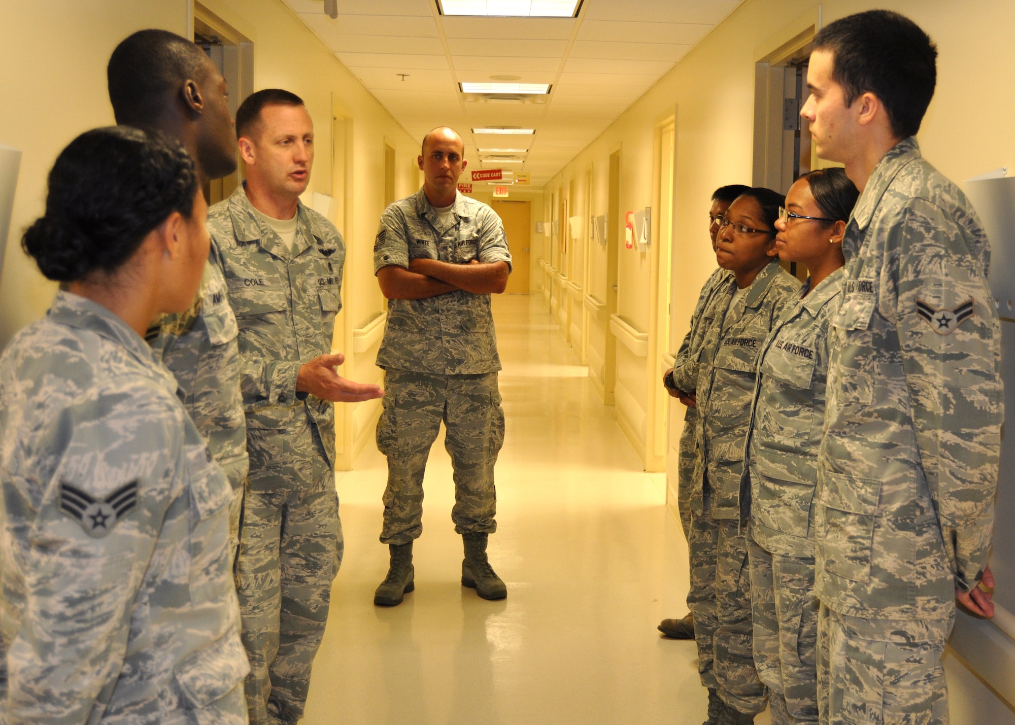 Chief Master Sgt. Charles Cole, third from left, talks with enlisted members of the 81st
Medical Operations Squadron family health flight during his June 23 visit to the Keesler Hospital. Chief Cole, the Air Force surgeon general’s chief of the medical enlisted force, spent the day meeting with many 81st Medical Group Airmen to update them on issues that affect them. From left are Senior Airman Sheene Giray, Airman 1st Class Ismail Amuessel, Tech. Sgt. DanielWhite, Master Sgt. Jerry Dameron, Staff Sgt. Makela Hutchins, Senior Airman Tina Anderson and Airman 1st Class Brent Weber.  (U.S. Air Force photo by Steve Pivnick)