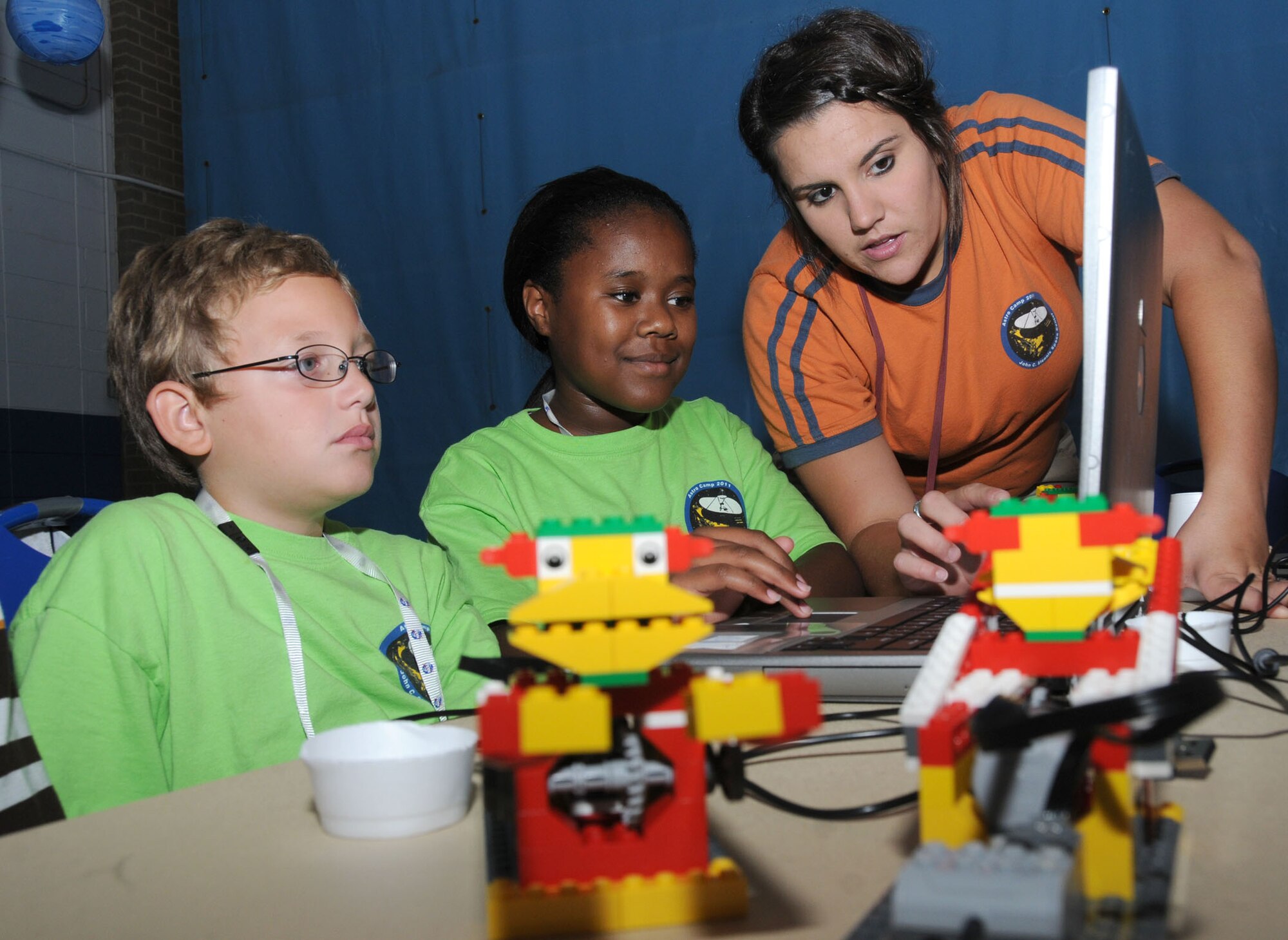 Brendan King, 9, and Keana Utsey, 12, learn about building, redesigning and controlling Lego robots from Stennis Space Center camp counselor Robyn Pascal June 30 during the youth center’s week-long Astro Camp. Brendan’s grandfather is
David Moore, 81st Comptroller Squadron. Keana’s parents are Master Sgts. Lee Utsey, 81st Aerospace Medicine Squadron, and Sharon Utsey, 335th Training Squadron. The camp ended with a trip to the space center in Hancock County.  (U.S. Air Force photo by Kemberly Groue)