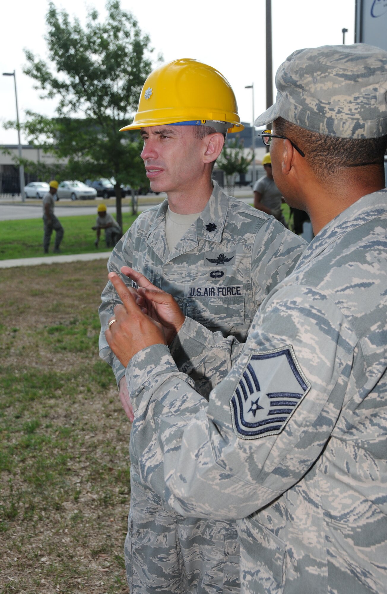 Lt. Col. Trevor Wall, left, 338th TRS commander, is briefed on high frequency antenna assemblies by Master Sgt. Albrecco Jackson outside Jones Hall July 5. Wall, former commander of the 332nd TRS, assumed his new duties June 29.   (U.S. Air Force photo by Kemberly Groue)