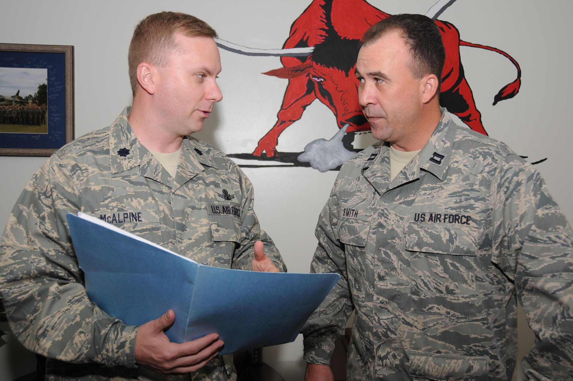 Lt. Col. Brad McAlpine, left, commander of the 335th Training Squadron, receives an orientation briefing July 5 from Capt. Scott Smith, acting director of operations. McAlpine, who took command June 30, came to Keesler from Peterson Air Force Base, Colo., where he was chief of strategic studies, doctrine and policy at Air Force Space Command headquarters.   (U.S. Air Force photo by Kemberly Groue)