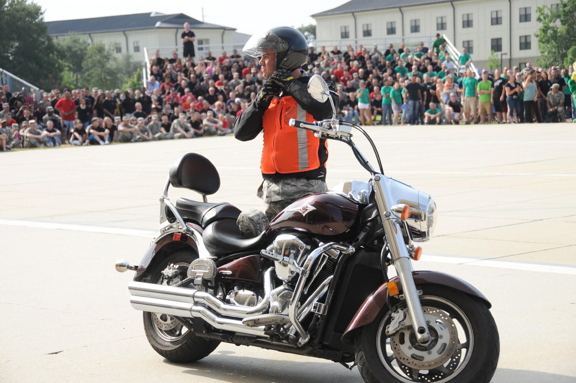 Staff Sgt. Edward Lotz, organizer of the motorcycle safety ride that took place after Friday's drill down, removes his helmet before speaking to 81st Training Group students.  The ride, part of the 81st Training Group’s motorcycle safety awareness campaign, is the second organized by Lotz and co-workers in the 336th Training Squadron.  (U.S. Air Force photo by Kemberly Groue)