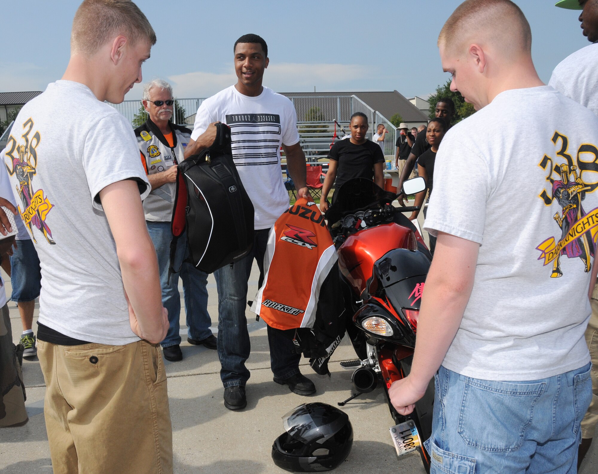 Master Sgt. Kendal Dismute, center, 81st Diagnostics and Therapeutics Squadron first sergeant, displays some of his motorcycle safety gear to Airman Basic Stephen Pase, left, and Airman 1st Class Ryan Schroeder, students in the 338th Training Squadron,
after Friday’s drill down. The ride, part of the 81st Training Group’s motorcycle safety awareness campaign, is the second organized by motorcyclists in the 336th Training Squadron.  (U.S. Air Force photo by Kemberly Groue)