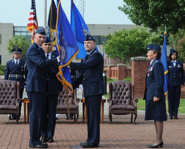 Col. Richard McComb accepts the 628th Air Base Wing guidon from Brig. Gen.
William Bender as Col. Martha Meeker and Chief Master Sgt. Jose LugoSantiago
stand at attention during the 628 ABW change of commander ceremony July 14
at Joint Base Charleston - Air Base. McComb is the new Joint Base Charleston
commander, Bender is the U.S. Air Force Expeditionary Center commander and
LugoSantiago is the 628 ABW chief. Meeker's new assignment is as Special
Assistant to the Commander, U.S. European Command, and Supreme Allied
Commander Europe, Supreme Headquarters Allied Powers Europe, Mons, Belgium.
U.S. Air Force photo/Staff Sgt. Nicole Mickle
