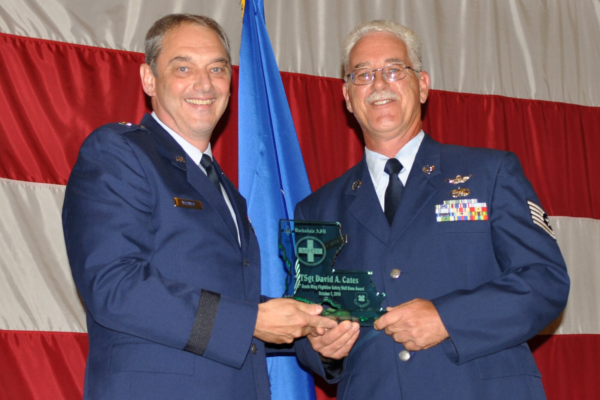 Brig. Gen. John J. Mooney III, the commander of the 307th Bomb Wing, poses with Technical Sgt. David Cates, an aircraft mechanic assigned to the 307th Aircraft Maintenance Squadron, during the Barksdale Reserve Awards Ceremony at Hoban Hall on Barksdale Air Force Base, La., July 10, 2011. Sergeant Cates was recognized with a Flightline Safety Well Done Award for his part in saving a valuable Air Force asset and possibly lives of aircrew when a B-52 Stratofortress brake fire started upon landing at Barksdale. (U.S. Air Force photo/Staff Sgt. Ted Daigle)