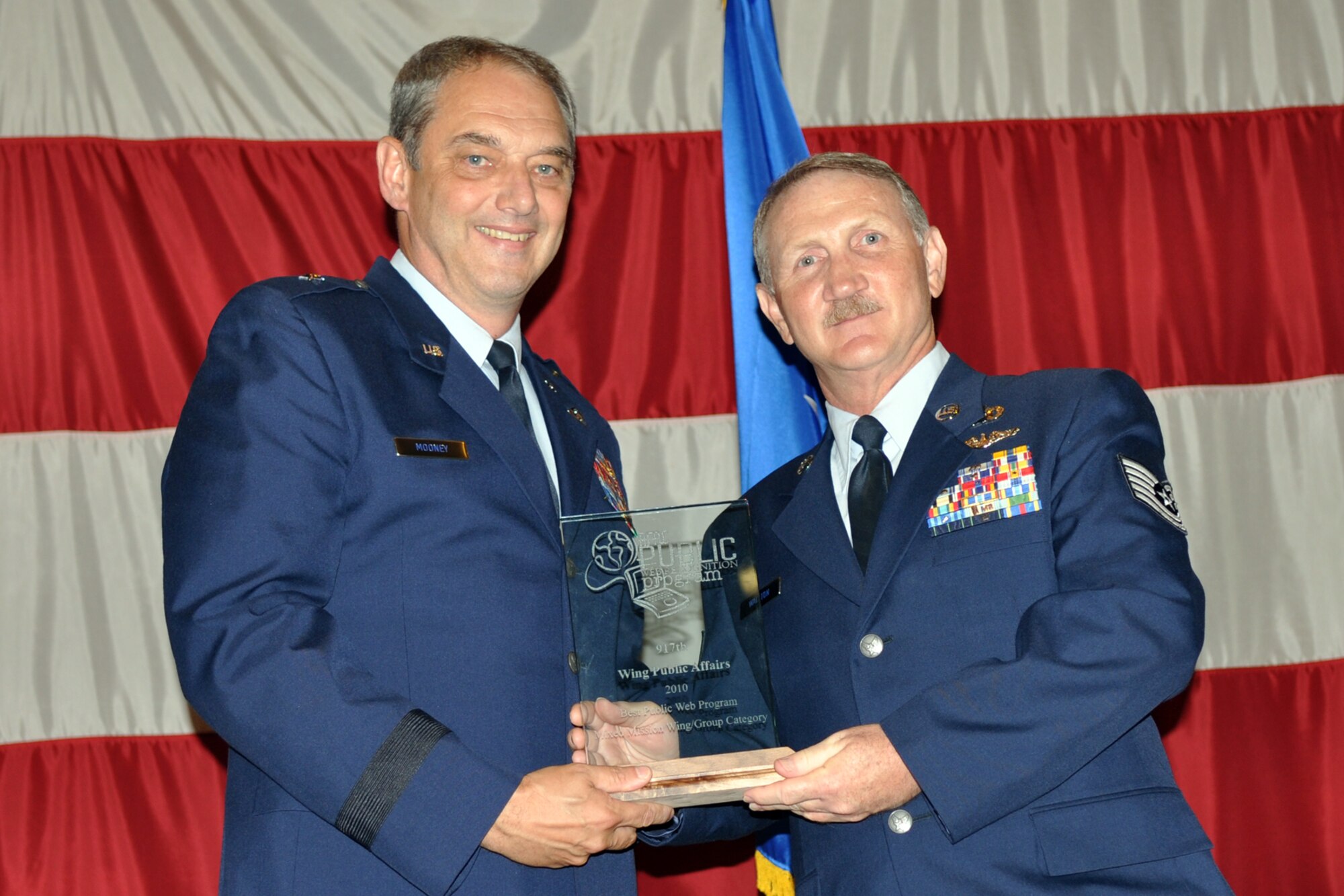 Technical Sgt. Jeff Walston accepts the 2010 Air Force Reserve Command Best Public Web Recognition Program award for the “Mixed Mission Wing/Group” from Brig. Gen. John J. Mooney III, commander, 307th Bomb Wing, at an awards ceremony during Commander’s Call in Hoban Hall at Barksdale Air Force Base, La., July 10, 2011.  Sergeant Walston, who is a public affairs technician, accepted the award on behalf of the 307th Bomb Wing’s Public Affairs office. This is the second year in a row that the 307th BW has won the award. The 307th BW now competes in a separate category since transitioning to a bomb wing with a single mission rather than a “dual” mission. (U.S. Air Force photo/Staff Sgt. Ted Daigle)