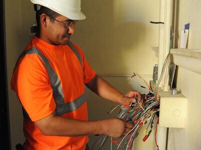 Steven Gallegos,electrical contractor, assesses  wiring during a base chapel renovation on Randolph Air Force Base July 7. (U.S. Air Force photo/Rich McFadden) (released)