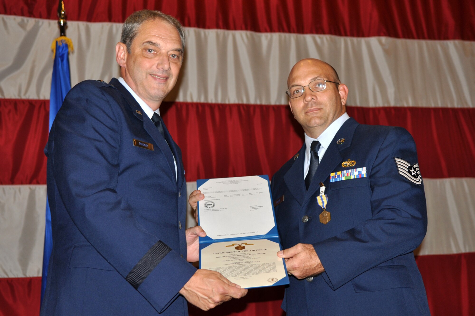 Brig. Gen. John J. Mooney III, the commander of the 307th Bomb Wing, poses with Technical Sgt. Dennis L. Green, a special purpose vehicle mechanic with the 917th Logistics Readiness Squadron after presenting him with the Air Force Commendation Medal during the Barksdale Reserve Awards Ceremony at Hoban Hall on Barksdale Air Force Base, La., July 10, 2011. Sergeant Green was awarded the medal for meritorious service while assigned to the 917th LRS from Nov. 4, 2006 to Nov. 6, 2010. (U.S. Air Force photo/Staff Sgt. Ted Daigle)