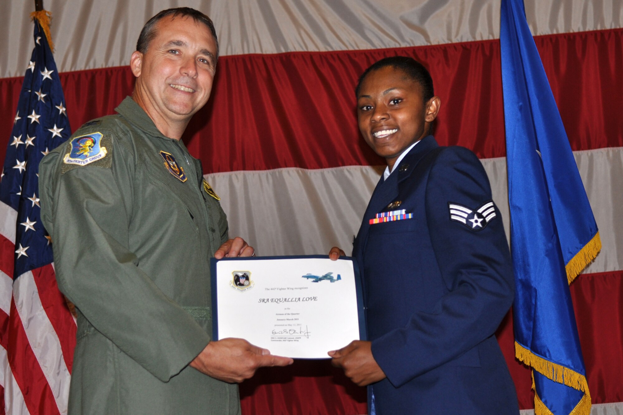 Colonel John Breazeale, the commander of the 917th Fighter Group, poses with Senior Airman Equallia Love, a munitions specialist from the 917th Maintenance Squadron, during the Barksdale Reserve Awards Ceremony at Hoban Hall on Barksdale Air Force Base, La., July 10, 2011. Airman Love was chosen the Reserve Airman of the Quarter for January to March 2011. (U.S. Air Force photo/Staff Sgt. Ted Daigle)