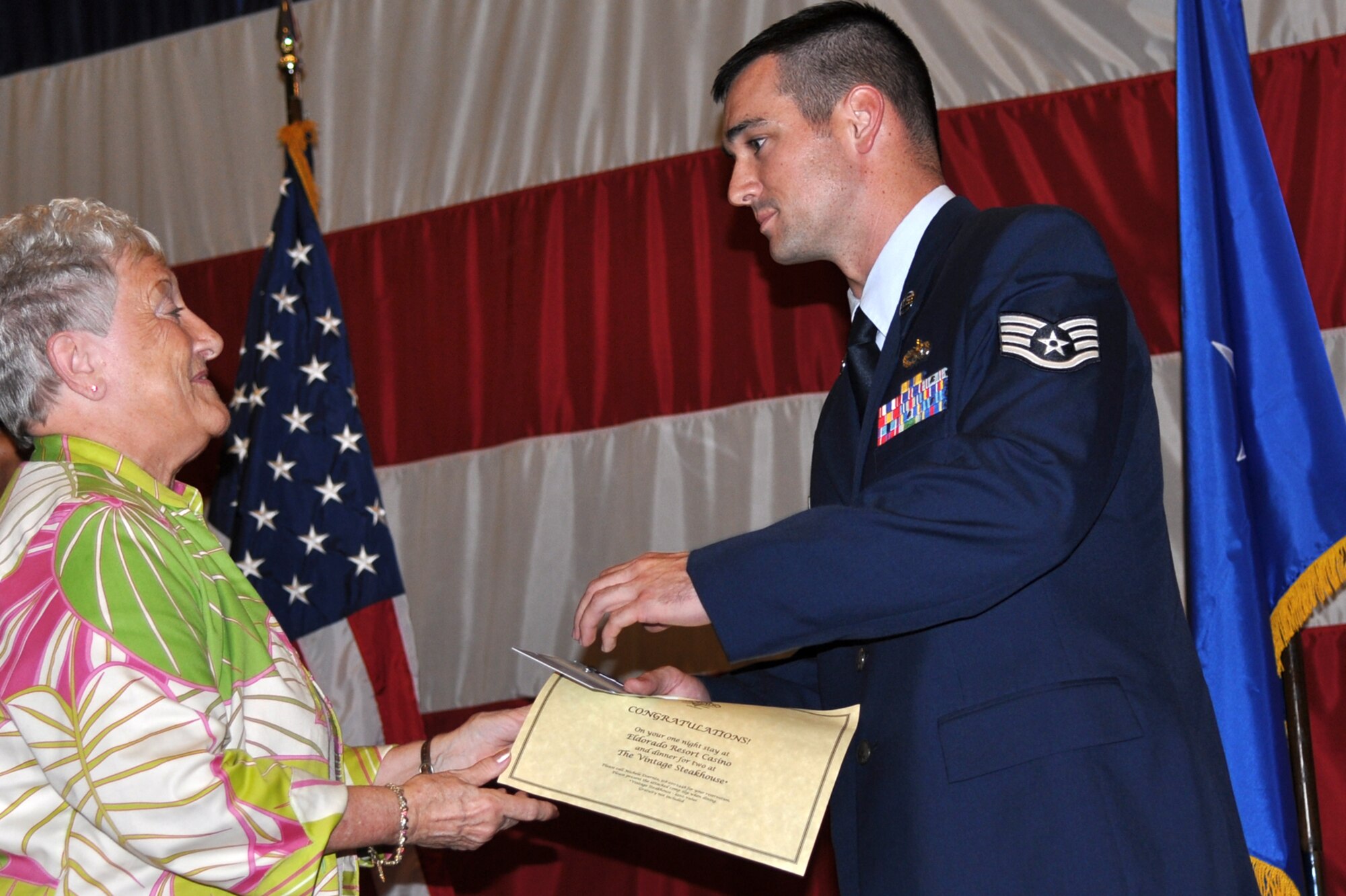 Mrs. Helen Black, from the El Dorado Casino and Resort, presents Staff Sgt. Jason Cohee, an aircraft structural maintenance craftsman assigned to the 917th Maintenance Squadron, with awards for being chosen the Reserve Noncommissioned Officer of the Quarter for January to March 2011. The awards were presented during the Barksdale Reserve Awards Ceremony at Hoban Hall on Barksdale Air Force Base, La., July 10, 2011. (U.S. Air Force photo/Staff Sgt. Ted Daigle)