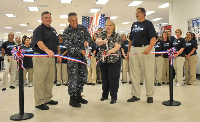 Jeff Wilder, Cdr. Charles Phillip, Angela Mauras and Joseph Puryer (left to right) cut the tape during a ribbon cutting ceremony July 12 at Joint Base Charleston - Air Base marking the completion of the 18-month renovation of the Exchange. Wilder is the Exchange Food Court manager, Phillip is the 628th Mission Support Group executive officer, Mauras is the Exchange general manager and Puryer is the Exchange project manager.  (U.S. Air Force photo/ Airman 1st Class Jared Trimarchi)