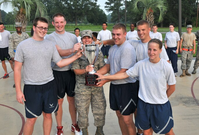 Col. Martha Meeker and residents of a Dormitory 466 pose for a group photo July 12 on Joint Base Charleston - Air Base.  Airmen from Dormitory 466 outshined five other dormitories in fitness, dormitory inspections, community involvement and camaraderie during the Dorm Excellence Warrior Ethos challenge. Meeker is the Joint Base Charleston commander. (U.S. Air Force photo/ Airman 1st Class Jared Trimarchi) 