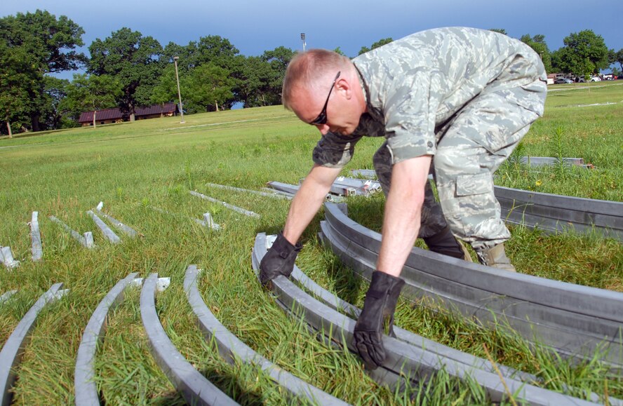 Maj. Alan Kilbourne, of the 178th Medical Group, Springfield, Ohio, readies tent framework during Expeditionary Medical Support Basic refresher training July 12 as part of Patriot Exercise 2011 at Volk Field Combat Readiness Training Center, Wis.  EMEDS Basic is designed to facilitate surgical and primary medical care in a deployed environment. (U.S. Air Force photo by Senior Airman Amy N. Adducchio/Released)