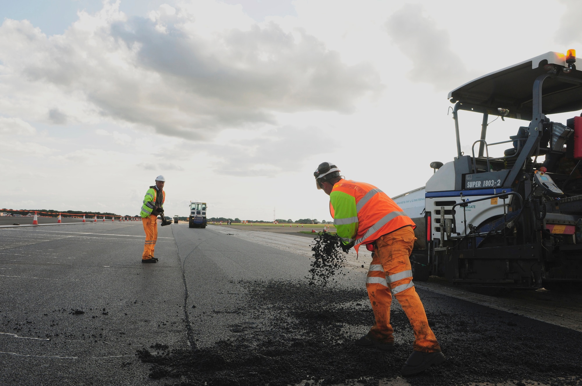 ROYAL AIR FORCE LAKENHEATH, England -- Construction workers with Volker Fitzpatrick contracting, repave a section of the RAF Lakenheath flightline, July 7, 2011.  The runway closure is part of a three year plan to renovate the entire flightline and is in the final phase of construction.  The project is scheduled for completion by July 18, 2011.  (U.S. Air Force photo/Staff Sgt. Connor Estes)
