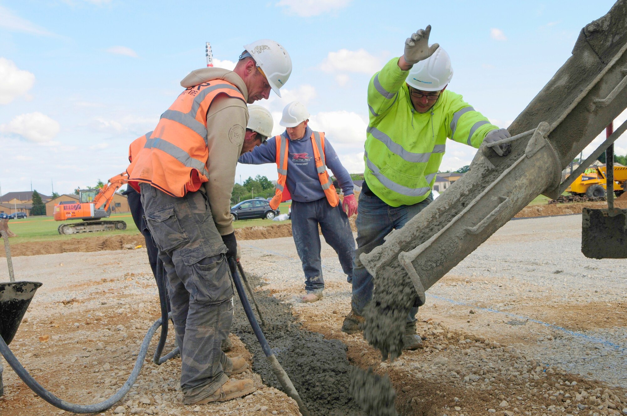 ROYAL AIR FORCE LAKENHEATH, England -- Construction workers with Volker Fitzpatrick contracting, fill in a trench with concrete on the flightline, July 7, 2011.  The runway closure is part of a three year plan to renovate the entire flightline and is in the final phase of construction.  The project is scheduled for completion by July 18, 2011.  (U.S. Air Force photo/Staff Sgt. Connor Estes)
