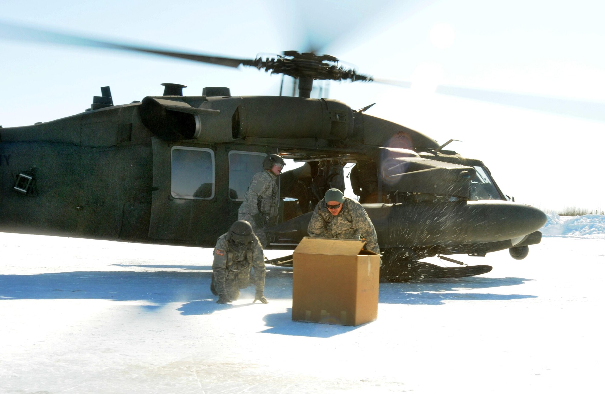 An Alaska National Guard flight crew makes a supply drop on a frozen runway in the Alaskan village of Nulato, April 16, 2011. The re-supply teams are a key element in the support of the Operation ARCTIC CARE 2011 mission. (U.S. Army photo by Sgt. Craig Anderson) (Released)