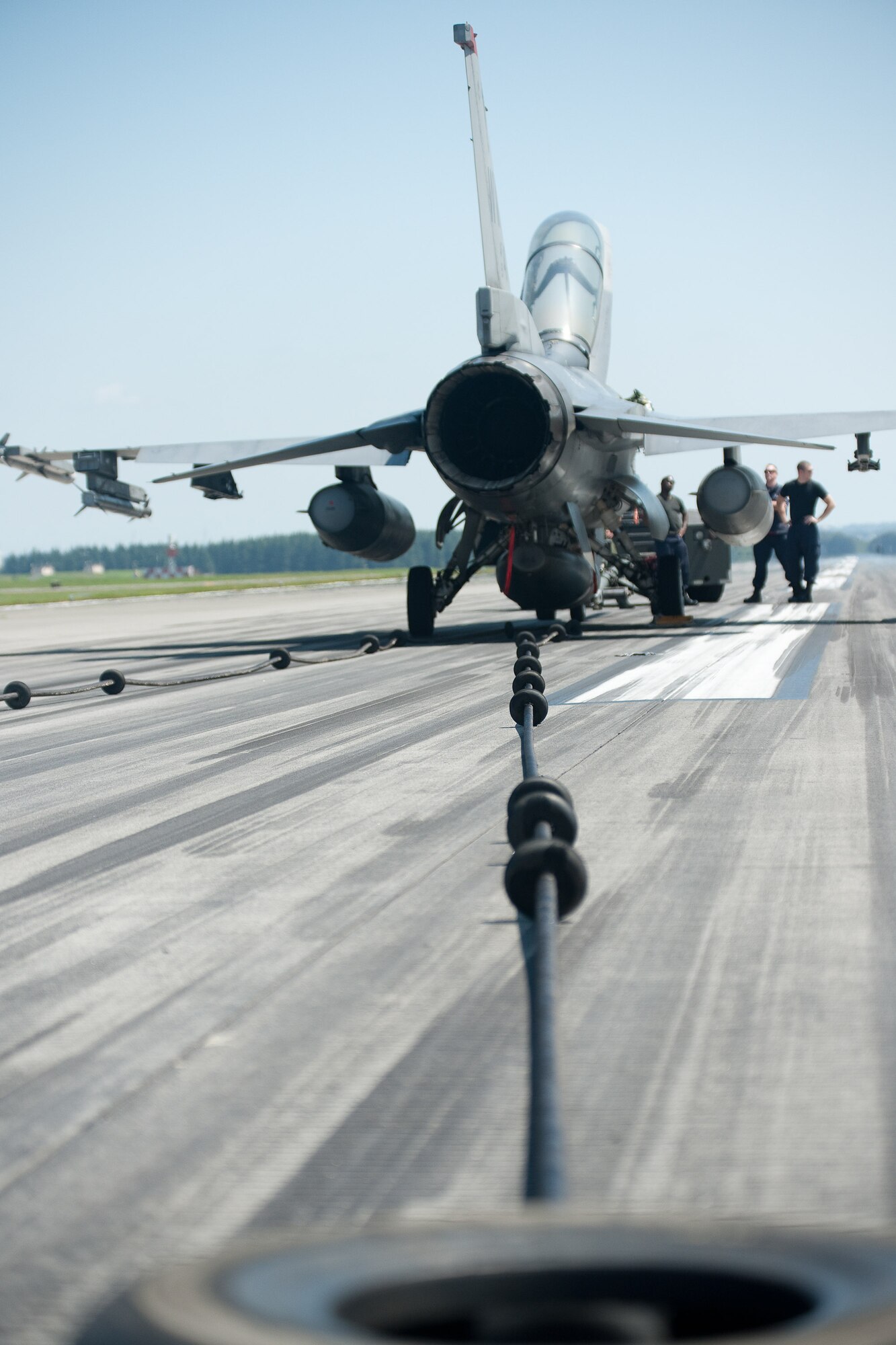 YOKOTA AIR BASE, Japan -- An F-16 Fighting Falcon from Misawa Air Base, Japan, is stopped by an aircraft arresting barrier system during annual test of the system at Yokota Air Base, July 13, 2011. The arresting gear is used in the event of an emergency where a fighter or similar aircraft cannot stop on its own. A tailhook catches the cable stretched across the runway and massive hydraulic reels slowly bring the aircraft to a stop. (U.S. Air Force photo/Osakabe Yasuo)