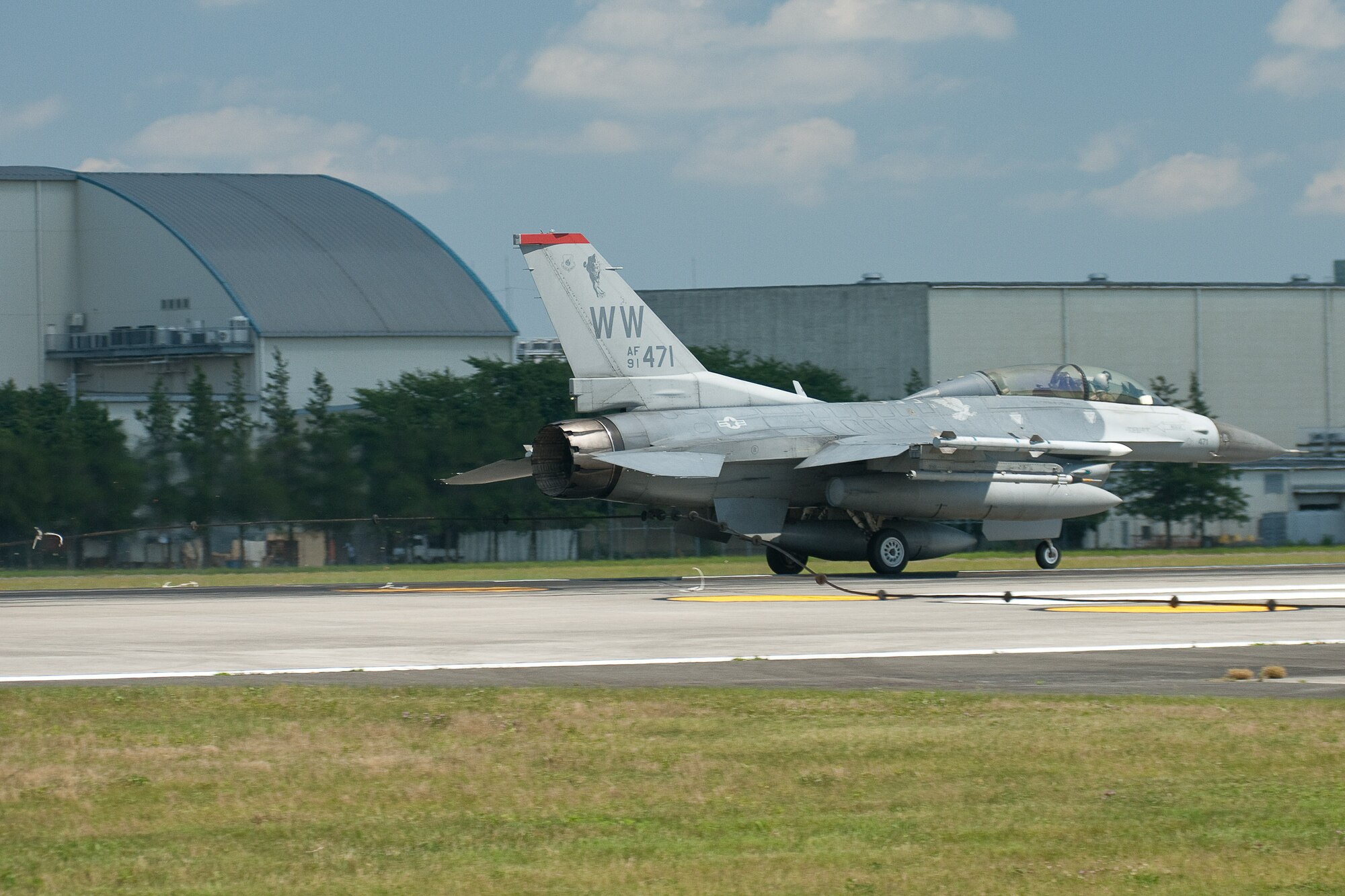 YOKOTA AIR BASE, Japan -- An F-16 Fighting Falcon from Misawa Air Base, Japan, stops with the assistance of arresting gear during an annual aircraft barrier system certification test at Yokota Air Base, July 13, 2011. The system is used in the event of an emergency where a fighter or similar aircraft cannot stop on its own. The aircraft's tailhook catches the cable stretched across the runway and massive hydraulic reels slowly bring the aircraft to a stop. (U.S. Air Force photo/Osakabe Yasuo)