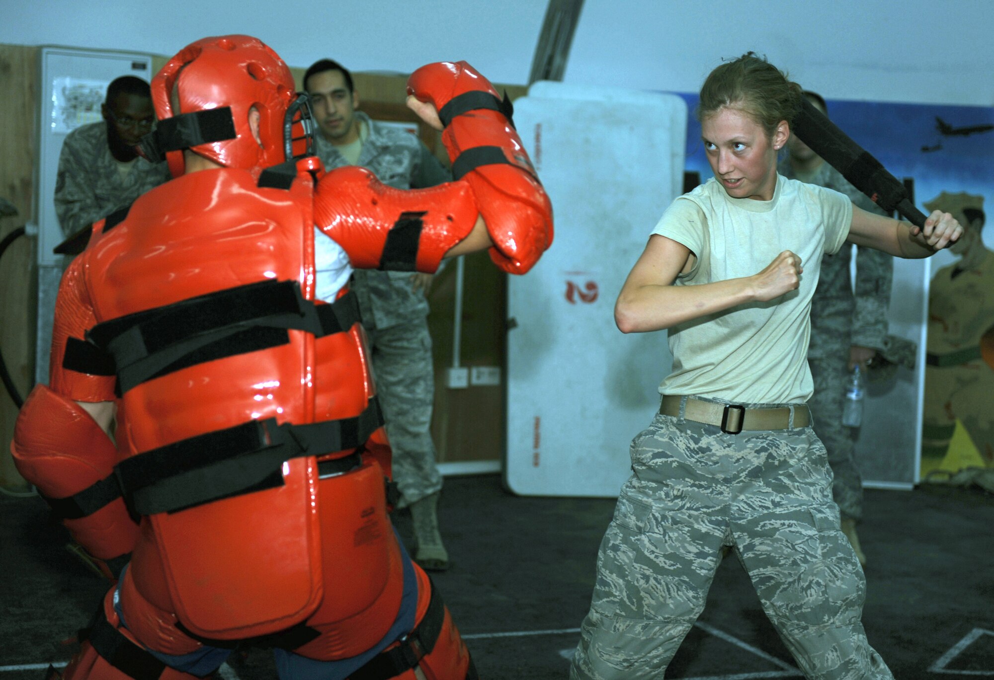 Cadet Yannie Horth takes a fighting stance against an attacker during a baton training drill with the 380th Expeditionary Security Forces Squadron. Horth is here as part of Operation Air Force-Deployed, a program designed to give cadets a firsthand view of a deployment. (U.S. Air Force photo/Master Sgt. Chance Babin)