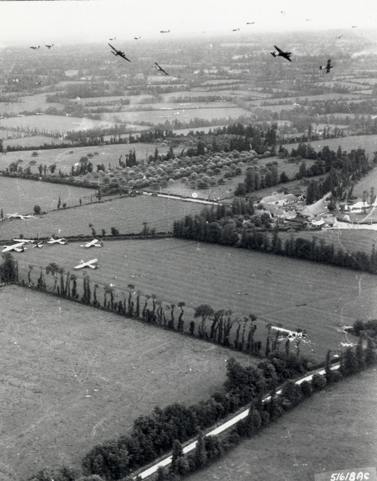 C-47s bank for England after their CG-4A gliders have cut loose from their tow lines. (U.S. Air Force photo)