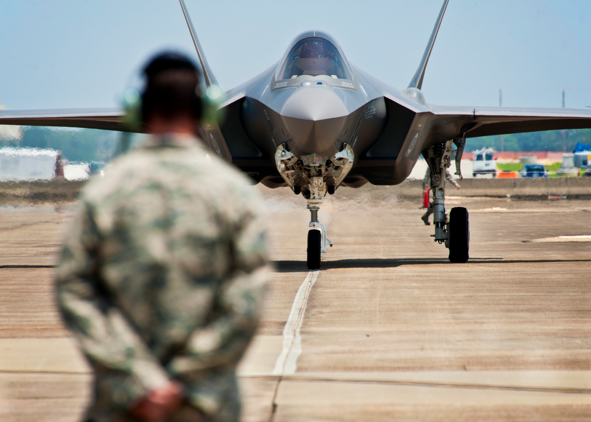 F-35 Lightning II joint strike fighter crew chief, Tech. Sgt. Brian West, watches his aircraft approach for the first time at Eglin Air Force Base, Fla., July 14.  Aircraft 0747 is DoD’s newest aircraft.  (U.S. Air Force photo/Samuel King Jr.)