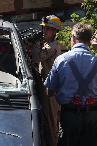 Lance Cpl. Joseph Aullman, an augment to Extraction Platoon, Initial Response Force B, Chemical Biological Incident Response Force gets cross training in vehicle extrication from a New York City Fire Department’s Special Operations Command fire fighter. Marines and sailors of CBIRF went through a week-long training evolution to involve vehicle extrication, rope rescue, and breaching and breaking through concrete. CBIRF’s Marines and sailors have trained with FDNY since July of 2000. Deputy Chief Raymond M. Downey, of FDNY’s SOC, helped CBIRF develop their technical rescue program before he later died on 9/11 in the World Trade Center towers. (released)