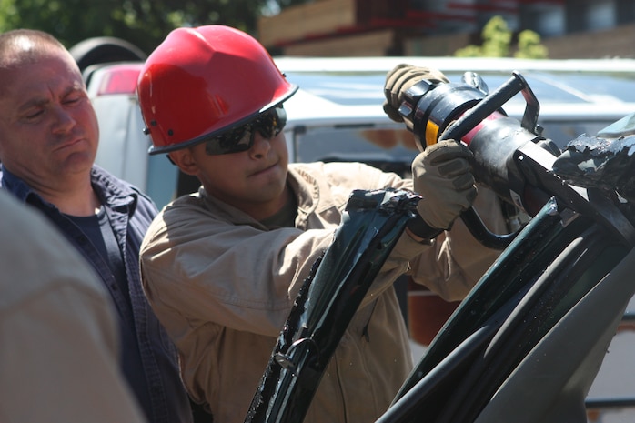 A Marine with Initial Response Force B, Chemical Biological Incident Response Force gets cross training in vehicle extrication from New York City Fire Department’s Special Operations Command fire fighters. Marines and sailors of CBIRF went through a week-long training evolution involving vehicle extrication, rope rescue, and breaching and breaking through concrete. CBIRF’s Marines and sailors have trained with FDNY since July of 2000. Deputy Chief Raymond M. Downey, of FDNY’s SOC, helped CBIRF develop their technical rescue program before he later died on 9/11 in the World Trade Center towers. (released)