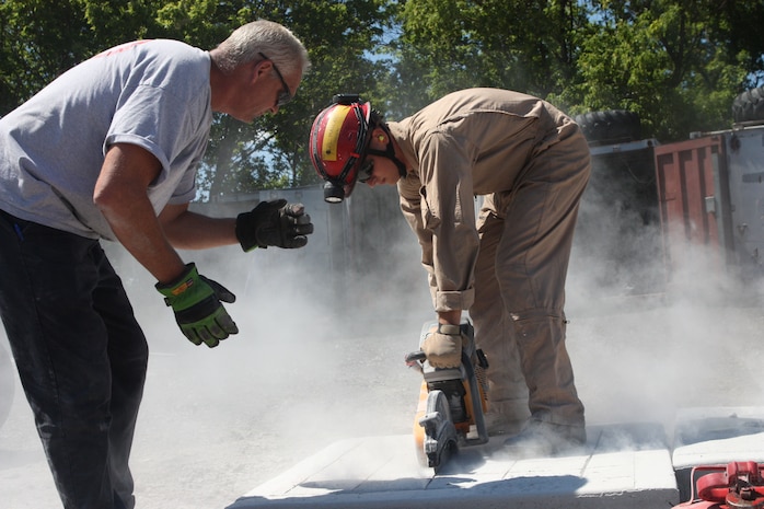 A Marine with Initial Response Force B, Chemical Biological Incident Response Force gets cross training in breaching and breaking through concrete from New York City Fire Department’s Special Operations Command fire fighters. Marines and sailors of CBIRF went through a week-long training evolution involving vehicle extrication, rope rescue, and breaching and breaking through concrete. CBIRF’s Marines and sailors have trained with FDNY since July of 2000. Deputy Chief Raymond M. Downey, of FDNY’s SOC, helped CBIRF develop their technical rescue program before he later died on 9/11 in the World Trade Center towers. (released)