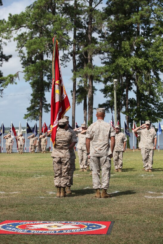 Col. Richard Fullerton hands over the Marine Corps Combat Service Support School’s colors to the incoming commanding officer, Col. Terri Erdag during a change of command ceremony aboard Camp Johnson. Erdag will be responsible for the Camp Johnson area as well as MCCSSS.