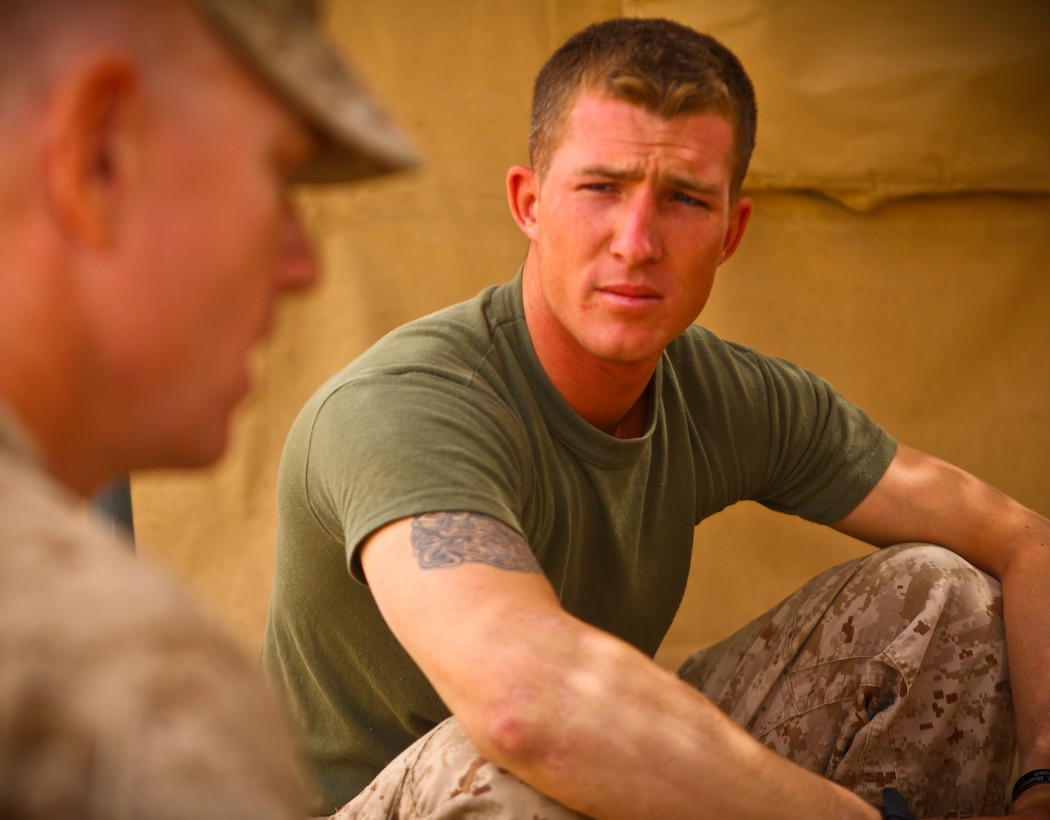 Lancaster, Pa., native Cpl. Chris Rickert, a 26-year-old assaultman with Company G, 2nd Battalion, 8th Marine Regiment, talks to fellow Marines in his company during a recent break in the day.  The 2003 Garden Spot High School graduate said he learned to stay mentally strong and focused during the seven-month deployment.  The unit spent the deployment eliminating insurgents from the Trek Nawa area and helping to increase security in the region.