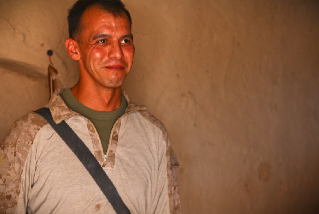 Albuquerque, N.M., native Sgt. Vincent Bachicha, a squad leader with 2nd Battalion, 8th Marine Regiment, stands inside a mud compound that makes up the patrol base.  Bachicha is part of a small detachment of Marines who is mentoring Afghan National Army soldiers to continue the vast improvements to security in the area.