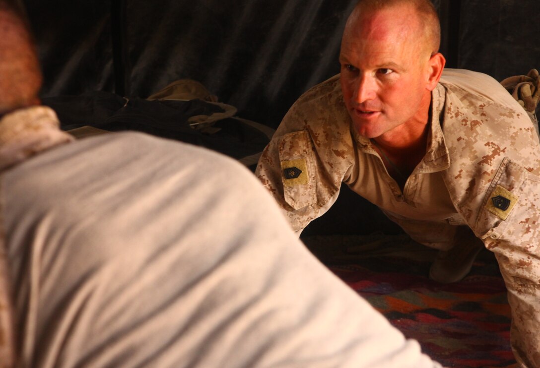 Sergeant Maj. Richard Mathern, the battalion sergeant major for 2nd Battalion, 8th Marine Regiment,  takes time to do push-ups with Marines of Company G.  Mathern recently spent the day traveling to the different patrol bases within the company’s area of operations, checking on Marines and sailors along the way.