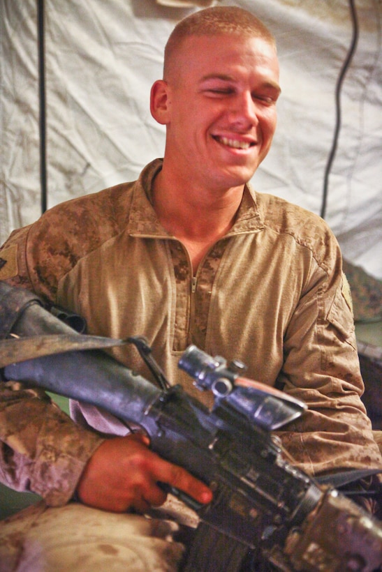 Endicott, N.Y., native Lance Cpl. Zachary Reardon, a rifleman with Company G, 2nd Battalion, 8th Marine Regiment,  poses for a photo and jokes with the Marines in his squad recently.  Reardon said he couldn’t wait to see his family when he returns home.  The Marines of the company spent their deployment clearing the area of Trek Nawa of insurgents and training Afghan National Army soldiers.