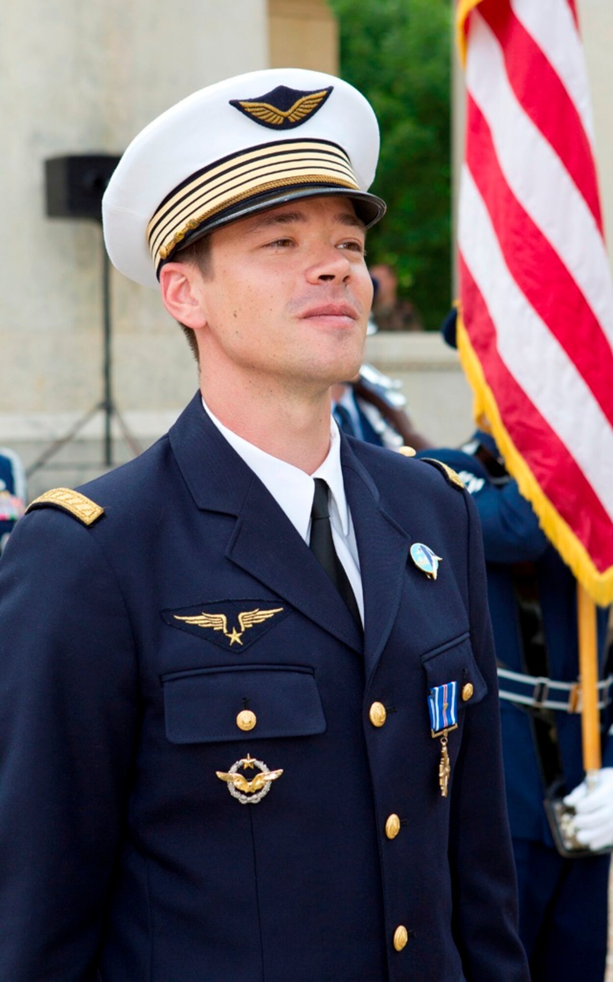 French air force Maj. Guillaume Vernet shows his pride after receiving the Distinguished Flying Cross with Valor from Air Force Chief of Staff Gen. Norton Schwartz July 13, 2011, at the Lafayette Escadrille Memorial in Marnes-la-Coquette, France. Vernet was awarded the decoration for repeatedly flying into hostile territory in December 2009 while deployed to Afghanistan as an exchange officer with the 41st Rescue Squadron from Moody Air Force Base, Ga.  During that mission, Vernet rescued an urgent casualty whose injury put the lives of 160 British soldiers in jeopardy.  (Courtesy photo)