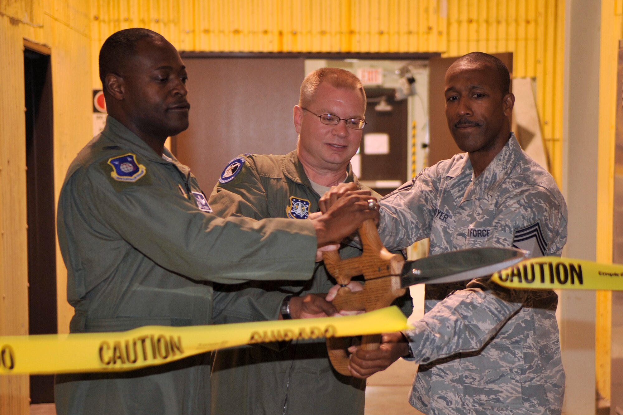 VANDENBERG AIR FORCE BASE, Calif. -- Col. Lavanson Coffey III, the 30th Launch Group commander, Lt. Col. Jenns Robertson, the 30th LCG director of operations, and Chief Master Sgt. Herman Moyer, the 30th LCG superintendent, cut a ribbon during the opening of the 30th LCG Bogart Bay ceremony here Friday, July 15, 2011.  The 30th LCG Bogart Bay provides a system of training components for 30th LCG members to gain experience and knowledge to use mission critical hardware.  (U.S. Air Force photo/Staff Sgt. Andrew Satran) 

  
 