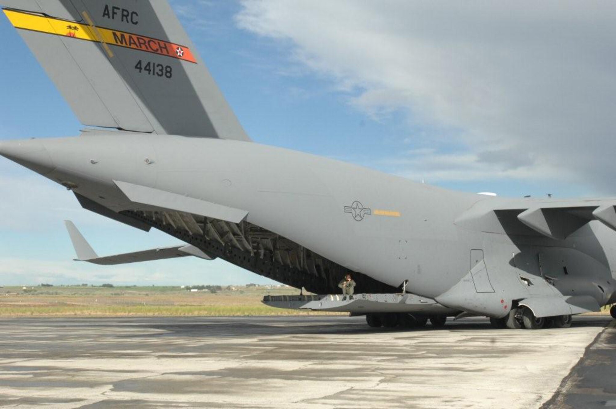 A March Air Reserve Base C-17 Globemaster III backs up at Moses Lake, Wash., guided by 729th Airlift Squadron loadmaster, Tech. Sgt. Rob Haberline, this month during a Rodeo 2011 practice. Rodeo is an Air Mobility Command-sponsored, international airlift and airdrop competition held July 23–30 at Joint Base Lewis-McChord, Wash.  (U.S. Air Force photo / Capt. Eric Ozols)
