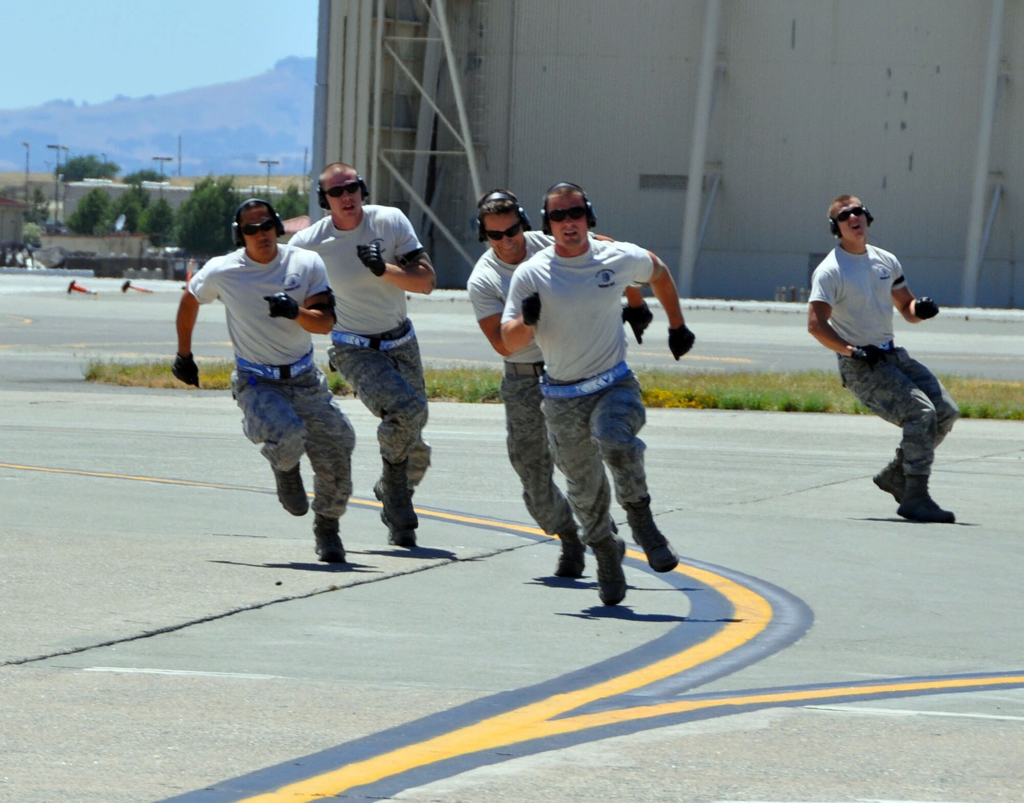 Members of the 60th Aerial Port Squadron run practice drills Tuesday in preparation for the 2011 Air Mobility Command Rodeo. (U.S. Air Force photo/ Airman 1st Class Michael Battles)
