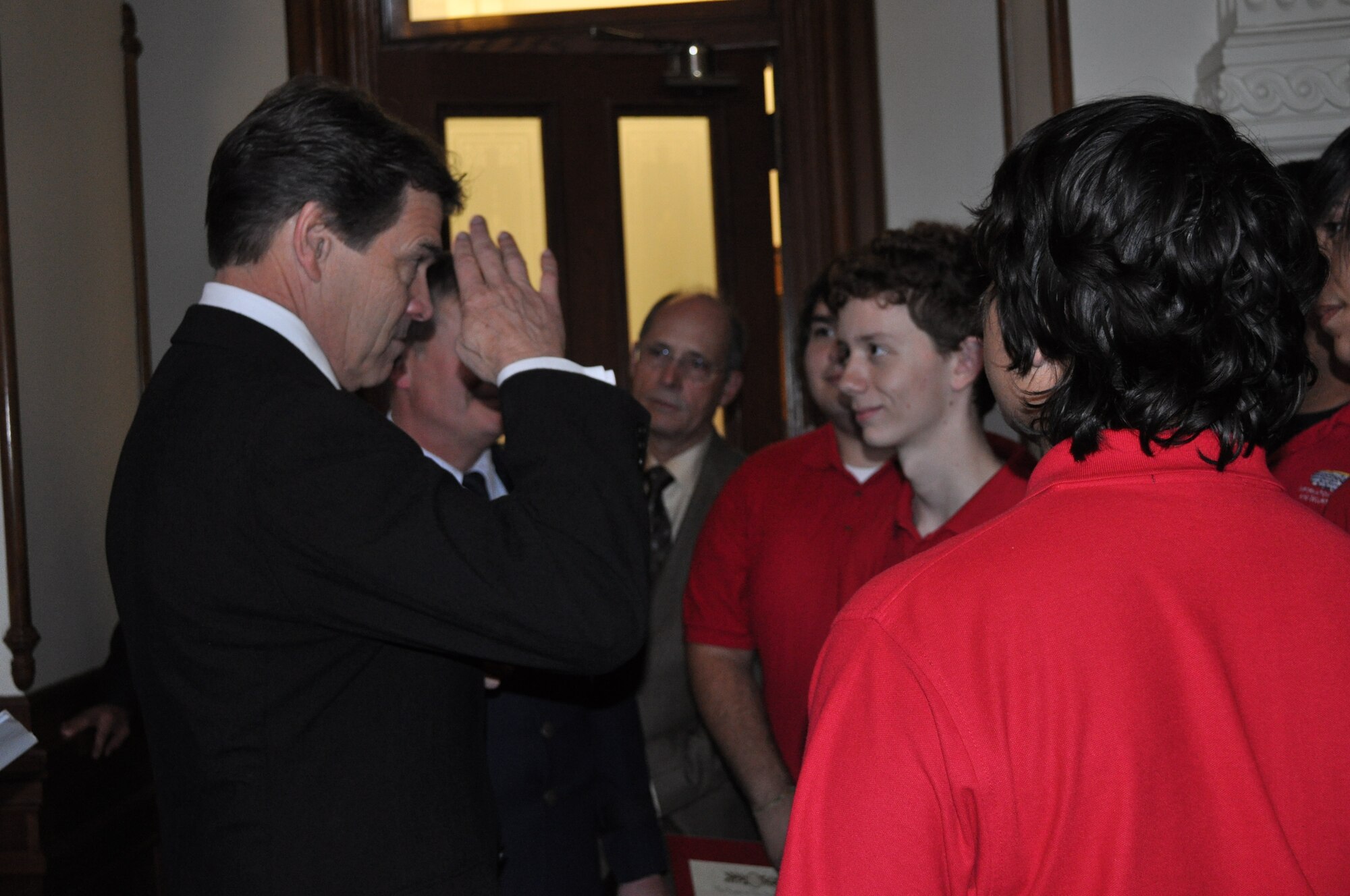 Texas Gov. Rick Perry salutes the members of the Alamo Colleges Information Technology and Security Academy team, including Lawrence "Tommy" Roberts, a junior at Warren High School (shown), after speaking with them at the Statehouse March 7. The team was recognized by both the Texas House and Senate after placing first in the regional competition of CyberPatriot. They subsequently placed third in the CyberPatriot national championships in April. They now work on the staff of the 33rd Network Warfare Squadron’s Air Force Computer Emergency Response Team – a subordinate unit of the 67th Network Warfare Wing and 24th Air Force. The summer hires will work right alongside other entry-level cyber operators, getting real-world experience. (U.S. Air Force photo by Christine D. Millette)
