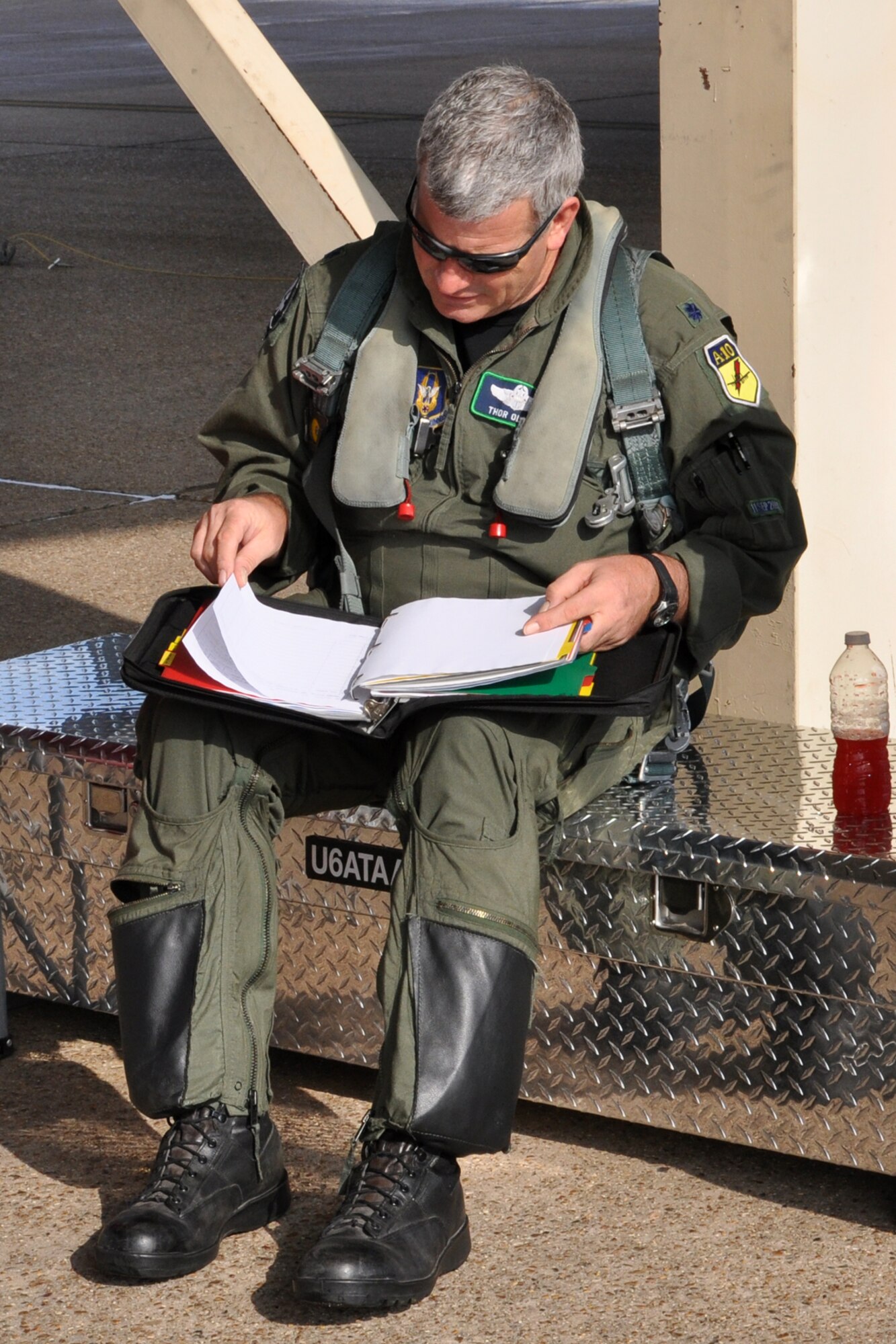 Lt. Col. Marc Olson, a pilot assigned to the 47th Fighter Squadron, checks the paperwork before climbing into an A-10 Thunderbolt II fighter jet at Barksdale Air Force Base, La., July 15, 2011. Colonel Olson participated in a four-ship flight, during which the pilots surpassed the 20,000 combined hours mark—a feat never before accomplished by four pilots in the A-10. (U.S. Air Force photo/Tech. Sgt. Jeff Walston) 