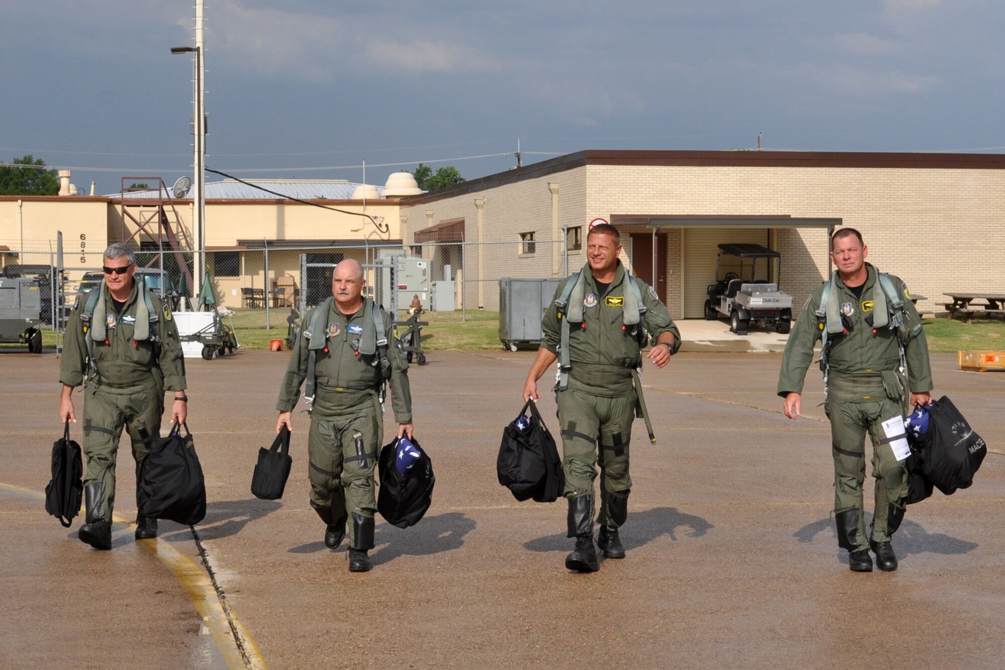 (L to R) Lt. Cols Marc Olson, David Deaton, Brady Glick, and James Macaulay, walk to their jets to participate in a four-ship flight at Barksdale Air Force Base, La., July 15, 2011. During their flight, they surpassed the 20,000 combined hours mark—a feat never before accomplished by four pilots in the A-10. The four Barksdale-based Air Force Reserve fighter pilots are assigned to the 47th Fighter Squadron. (U.S. Air Force photo/Tech. Sgt. Jeff Walston)

