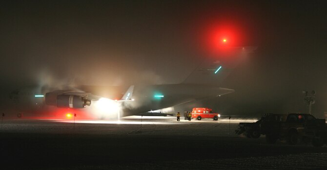 A C-17 from McChord Field, Washington, sits on the ice in Antarctica June 30, 2014, awaiting a patient for a medical evacuation. A crew mix of 446th Airlift Wing Reservists and 62nd Airlift Wing active-duty Airmen flew this mission using night-vision googles. (Courtesy photo) 

