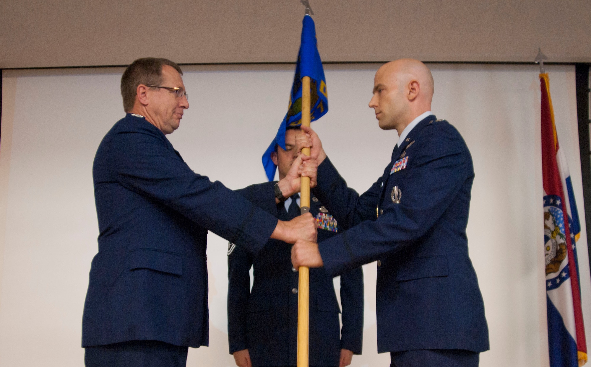 Col. Vince Teuber, Advanced Airlift Tactics Training Center commander, hands the Detachment 5 guidon to Lt. Col. Christopher M. Parker during an assumption of command ceremony at the Missouri Air National Guard’s 139th Airlift Wing, St. Joseph, Mo., July 15, 2011. Parker becomes the second commander of Detachment 5, HQ AMC Air Operations Squadron since its move here in 2009. (U.S. Air Force photo by A1C Kelsey Stuart)