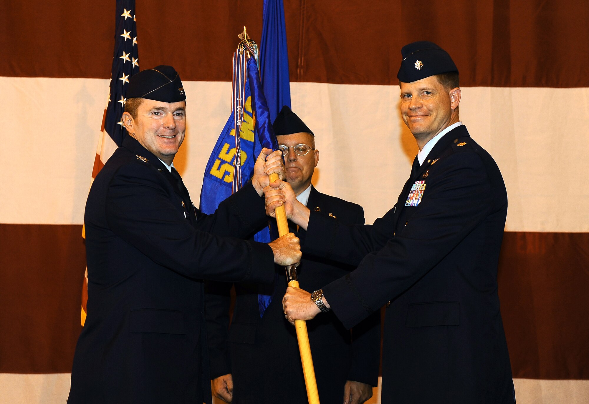 Air Force Lt. Col. Jeffrey P. Ford, (right), assumes command of the 97th Intelligence Squadron during a change-of-command ceremony held in Dock 1 of the Bennie Davis Maintenance Facility, on Offutt Air Force Base, Neb., July 15. Col. John M. Hansen, commander of the 55th Operations Group, presided over the ceremony welcoming Ford to the Squadron.  (U.S. Air Force Photo by Josh Plueger/ Released)