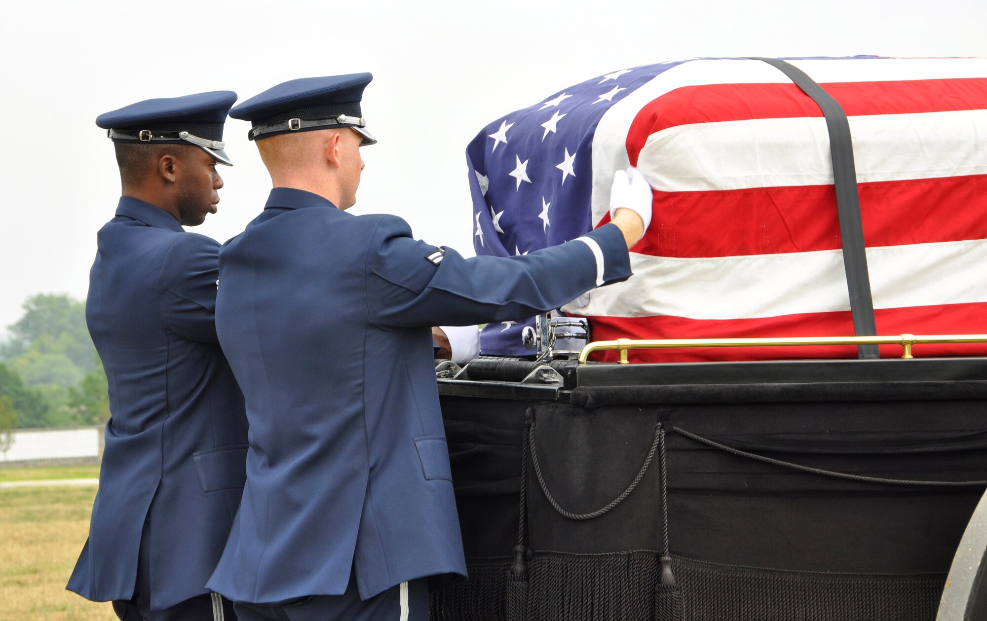 Members of the Bolling Air Force Base Honor Guard drape the U.S. flag over Maj. Richard D. Elzinga’s casket during a graveside inurnment service at Arlington National Cemetery, Va., July 8, 2011. The service includes full military honors for missing in action servicemembers. (U.S. Air Force photo/Capt. Pamela Stauffer)