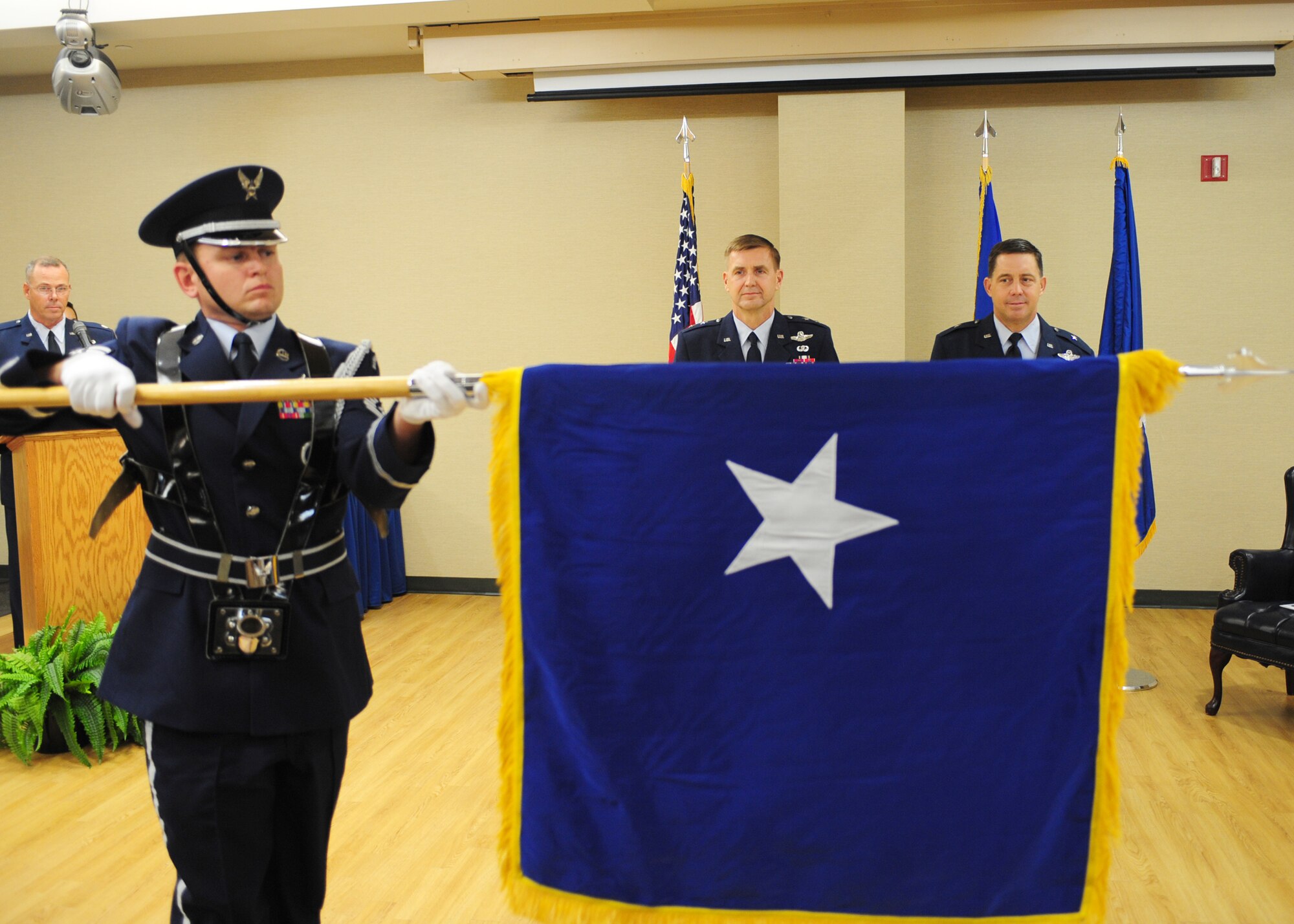 A Moody Air Force Base Honor Guard member unfurls Brig. Gen. John Horner’s, 93rd Air Ground Operations Wing commander, general officer flag for the first time during his promotion ceremony at Moody Air Force Base, Ga., July 14, 2011. General officers are presented with their own flag upon promotion to brigadier general. (U.S. Air Force photo by Senior Airman Stephanie Mancha/Released)