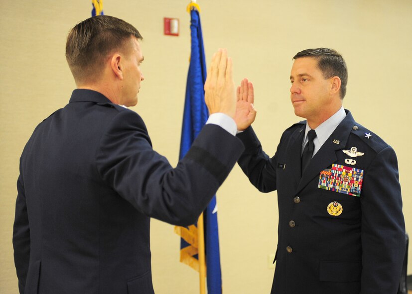 U.S. Air Force Brig. Gen. John Horner, 93rd Air Ground Operations Wing commander, recites the oath of office to Maj. Gen. Stephen Hoog, 9th Air Force commander, during his promotion ceremony at Moody Air Force Base, Ga., July 14, 2011. It is traditional for officers to recite the oath upon promotion. (U.S. Air Force photo by Senior Airman Stephanie Mancha/Released)