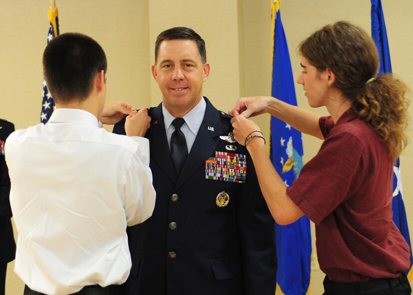 U.S. Air Force Col. John Horner, 93rd Air Ground Operations Wing commander, receives his brigadier general pins from his two sons Thomas and Sam at Moody Air Force Base, Ga., July 14, 2011. Also in attendance were Horner’s parents, sister and nieces to help celebrate the occasion of his promotion. (U.S. Air Force photo by Senior Airman Stephanie Mancha/Released)