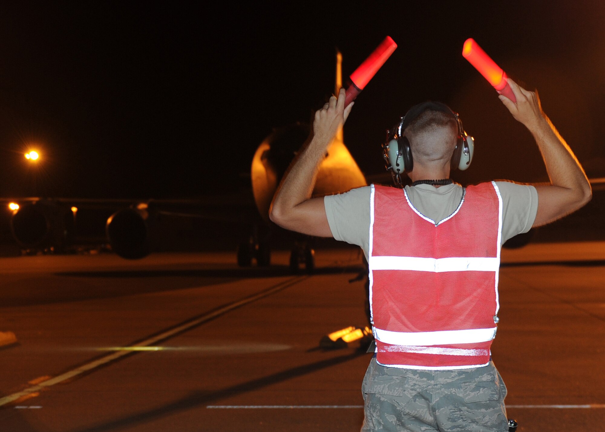 Airman 1st Class Nicholas Grygiel, 22nd Aircraft Maintenance Squadron crew chief, marshals an aircraft July 6, 2011, McConnell Air Force Base, Kan.  McConnell’s crew chiefs perform end-of-runway, postflight, preflight, thru-flight and phase inspections at all hours.  McConnell squadrons and units perform 24-hour operations to accomplishTeam McConnell’s war-fighting mission. (U.S. Air Force Photo/Airman 1st Class Katrina M. Brisbin)