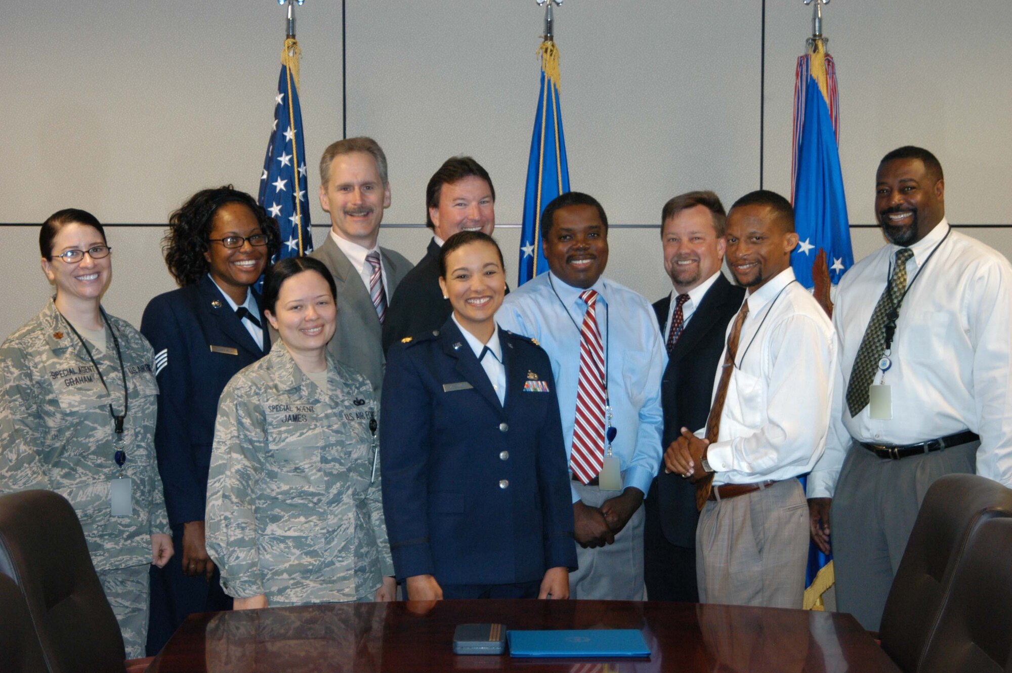 NCIS Special Agent George Murphy (fourth from left) joins his AFOSI counterparts for a group picture after receiving the Meritorious Civilian Service Award. SA Murphy worked at the OSI headquarters for two years as the deputy director of the Directorate of Warfighter Readiness and Execution and was being honored for his work within this directorate. (U.S. Air Force by Mr. James C. Dillard)