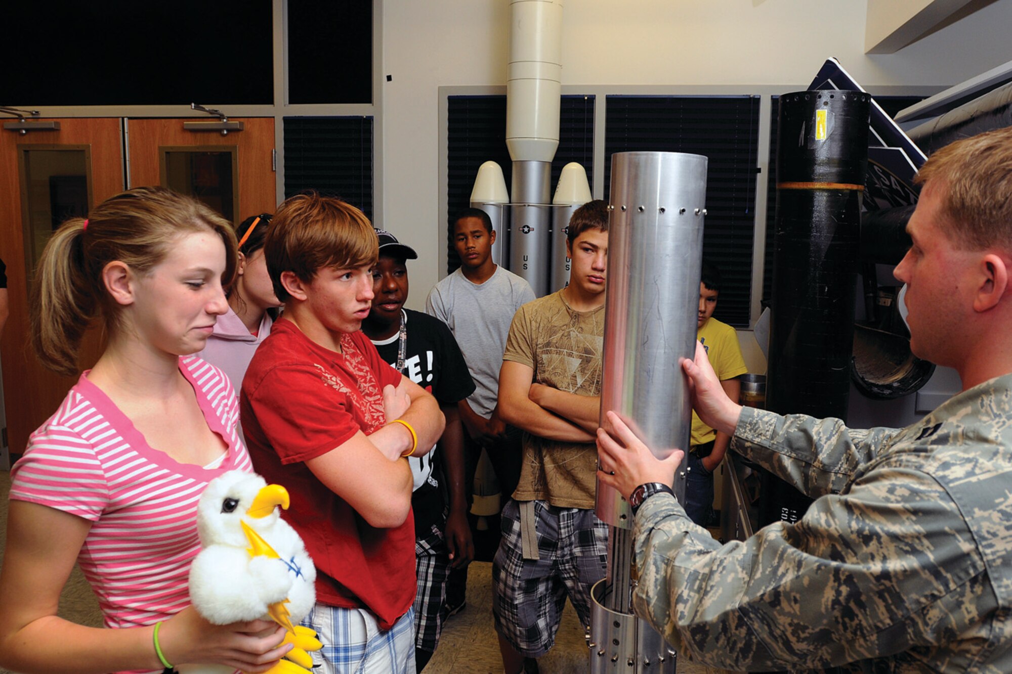 Capt. Uriah Tobey, an instructor in the U.S. Air Force Academy's Astronautics Department, explains the history of FalconLAUNCH, the Academy’s rocket launch program, to a group of high school students July 7.  Here, he describes a liquid rocket designed by former Academy Astronautics students.  The students are part of a Colorado and Missouri National Guard youth program taking part in a local summer camp designed to increase interest in science, technology, engineering and mathematics.    (U.S. Air Force Photo/Raymond McCoy)
