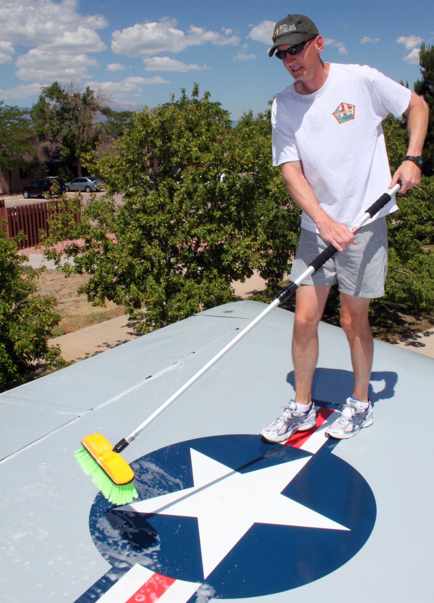 Lt. Co.l Andrew Rowland washes the wing of a retired F-106A on June 24 at the Peterson Air Force Base Museum. He was one of the seven 7 SOPS volunteers who cleaned up the dusty Delta Dart. The museum has 17 aircraft, including three Army missiles on display. To help care for an aircraft, call the museum at 556-8314. (U.S. Air Force photo by Scott P. Farley)